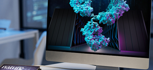 antibody and supercomputer on a laptop screen with the Nature cover image on the desktop