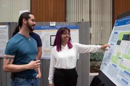 Ian Lee mentors his summer student at a poster session
