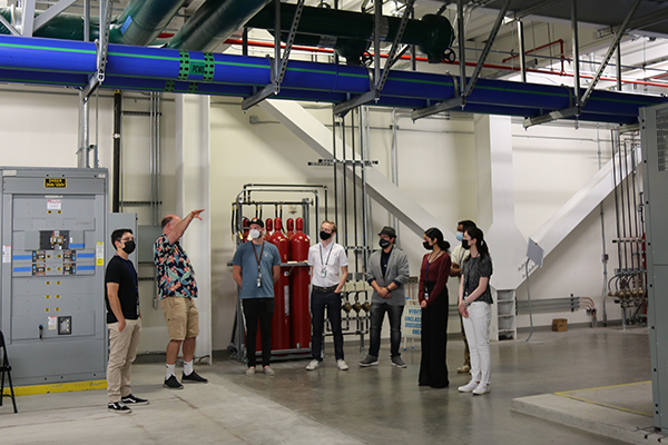 Interns on a guided tour beneath the machine room