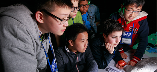 several students grouped around a computer screen