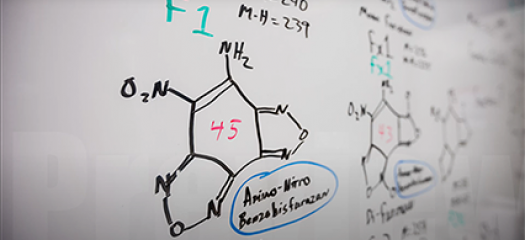 molecular structures drawn on a whiteboard