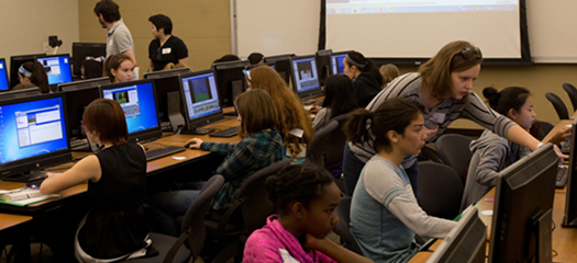 mentors and students work in a computer lab