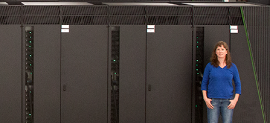 Kathryn Mohror is dwarfed by the now-retired Sequoia supercomputing system