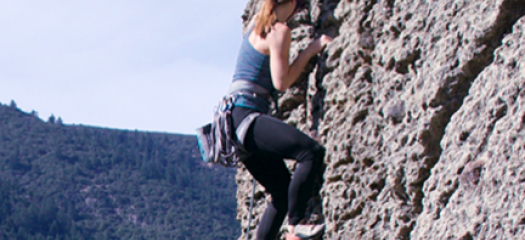Rachael climbing a rock face