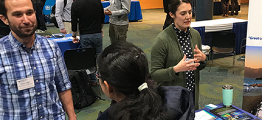 conference attendees at a recruiting booth