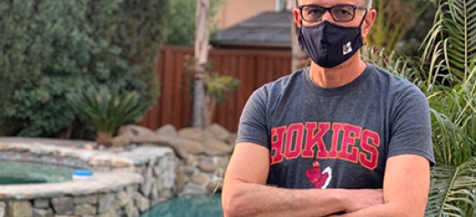 photo of Ghaleb who is wearing a mask poolside