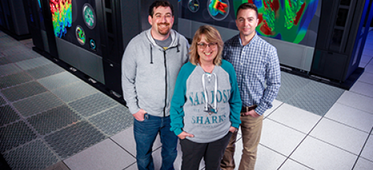 Some of the LLNL HPSS team in front of one of our tape storage systems: Herb Wartens, Debbie Morford, and Todd Heer
