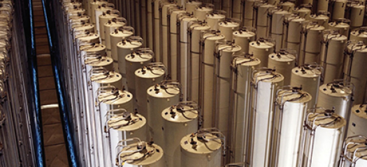 Hundreds of tall cylinders arranged pair-wise in rows, photographed from an elevated vantage point