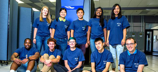 students and mentors posed as a group in the machine room