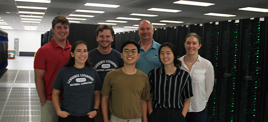 students and mentors posed as a group in the machine room