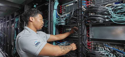 a person connects wires inside the supercomputer's racks