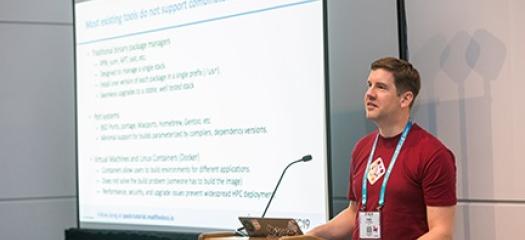 Todd at a lectern next to a presentation screen