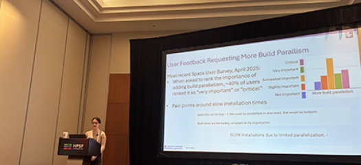 Kathleen presenting at a podium in front of a big screen, which shows a slide titled “User Feedback Requesting More Build Parallelism”