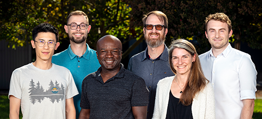 six people stand in a group