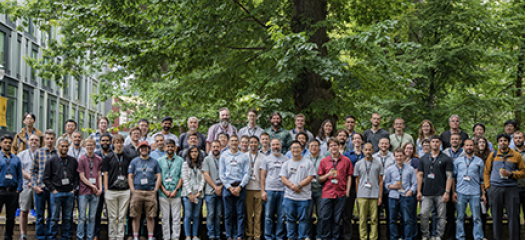 Group of about 60 workshop attendees posed outside on the PSU campus