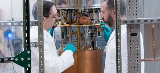 two people examine copper-plated cavity tech