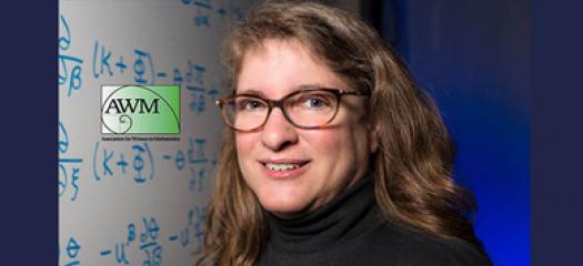 Carol Woodward in front of a whiteboard covered in math notations