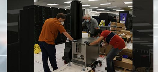 three people install Cerebras components in the HPC machine room