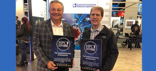 two men holding award plaques