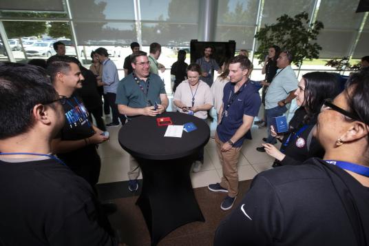 A group of people standing around a table.