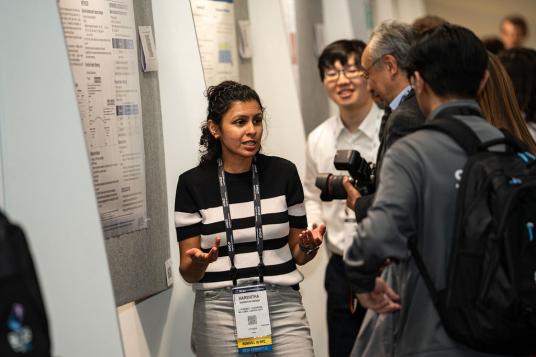Harshitha explains her team’s poster to onlookers