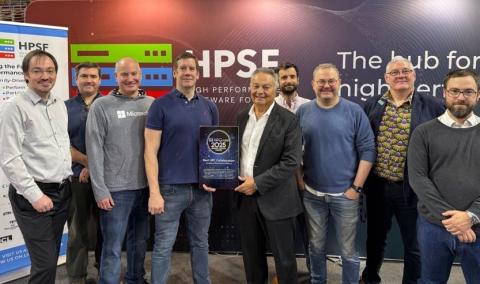 Spack team accepts an award in front of an HPSF banner
