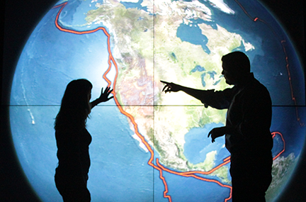 Scientists in front of an earthquake visualization