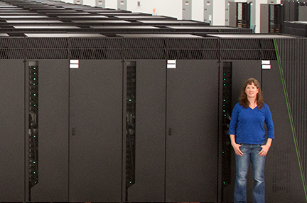 Kathryn Mohror is dwarfed by the now-retired Sequoia supercomputing system