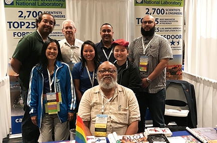 group of diverse Computing employees posing at the Lab's 2019 Tapia Conference recruiting booth