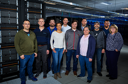 11 members of the Scalable Storage group standing in front of an ASP system