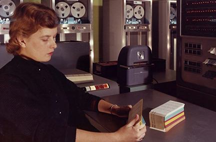 Unidentified employee (Ruth Kilby, possible) with IBM 704, November 1957