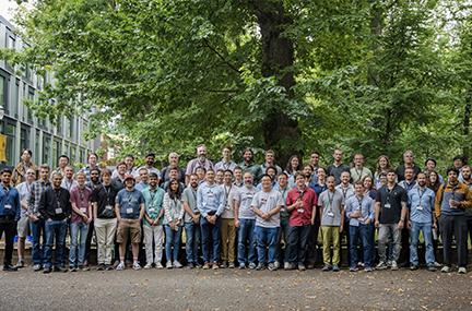Group of about 60 workshop attendees posed outside on the PSU campus