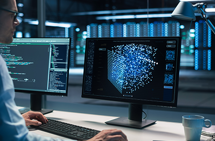 Adobe stock image of a developer at a workstation with code on one monitor and a simulation on the other; background is an HPC center