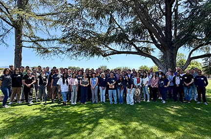 large group of CASC members posed in a city park