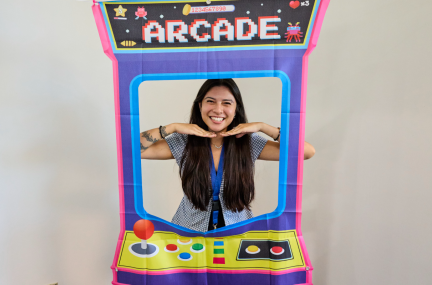 Maili smiles in a retor Arcade-style photo stand-in.