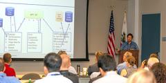 Sasha at a podium presenting ESGF work