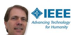Photo of Bronis next to IEEE logo