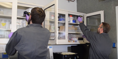 two people conduct RFI scanning in a supply cabinet