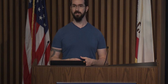 Ian speaking at a podium