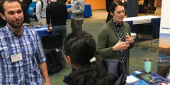 conference attendees at a recruiting booth