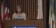 Lori speaking from a podium