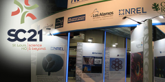 SC21 logo overlaid on photo of DOE's exhibitor booth