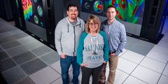 Some of the LLNL HPSS team in front of one of our tape storage systems: Herb Wartens, Debbie Morford, and Todd Heer