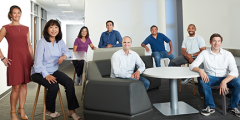 eight people gathered around sofas and tables