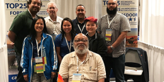 group of diverse Computing employees posing at the Lab's 2019 Tapia Conference recruiting booth