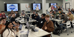 students and mentors strike casual poses in the UCLCC meeting room