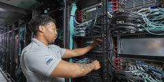 a person connects wires inside the supercomputer's racks