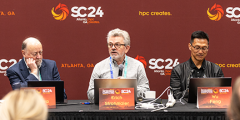 three people at a table with microphones in front of an SC24-branded backdrop