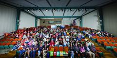 large group of students and mentors in auditorium seats