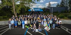 Large group of mostly students poses outside of the LLNL Discovery Center